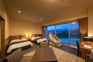 Giường trong phòng chung tại Enakyo Onsen Hotel Yuzuriha