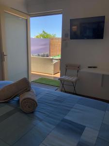 a bedroom with a bed and a sliding glass door at WAVE N' SOUL in Dunsborough