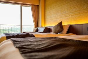 Giường trong phòng chung tại Enakyo Onsen Hotel Yuzuriha