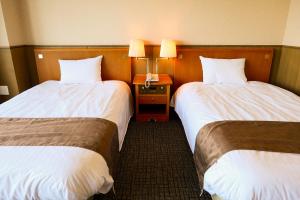 Giường trong phòng chung tại Enakyo Onsen Hotel Yuzuriha