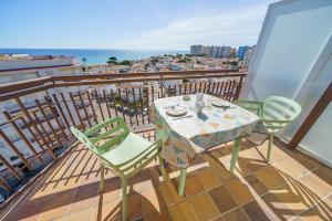 a table and chairs on a balcony with a view of the ocean at AR Apartaments Camps in Blanes