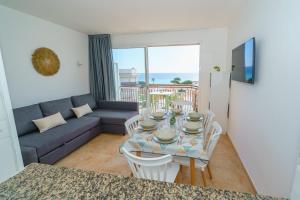 a living room with a table and a couch at AR Apartaments Camps in Blanes