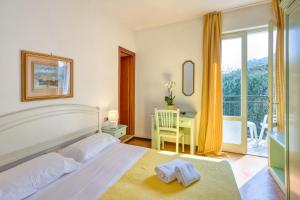 Postel nebo postele na pokoji v ubytování Hotel Silvana Garnì