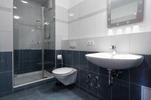 a bathroom with a sink and a toilet and a shower at Residenz Bel Vital Wohnung 41 in Binz