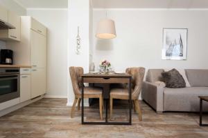 a kitchen and dining room with a table and a couch at Residenz Bel Vital Wohnung 41 in Binz