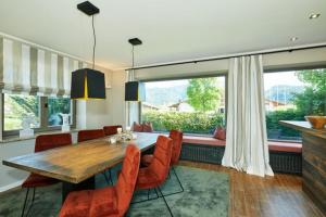 a dining room with a wooden table and chairs at Haus Almrose in Reit im Winkl