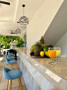 a bar with fruits and drinks on a counter at Harbour Bliss Hotel in Coron
