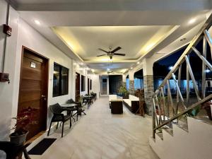 a living room with a ceiling fan and a balcony at Harbour Bliss Hotel in Coron