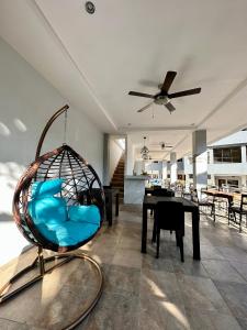a swing in a living room with a table at Harbour Bliss Hotel in Coron