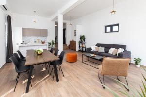 a living room with a table and chairs and a couch at Apartments Suzy in Šibenik