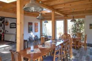 a dining room with a large wooden table and chairs at Appartement-fuer-2-Personen-in-Schaprode-auf-der-Insel-Ruegen-Zi2 in Schaprode
