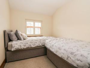 a bedroom with a large bed and a window at The Anvil in Broughton in Furness