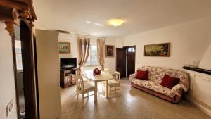 a living room with a table and a couch at Casa Antonietta in Orosei