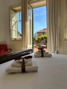 a room with towels on a bed with a window at mondello beach luxury apartments in Palermo