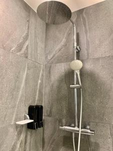 a shower with a shower head in a bathroom at Amazing View The Astra Sky River, Chiang Mai in Chiang Mai