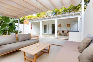 a living room with a couch and a table at Ses Eufabietes Apartments & Restaurant in Sant Francesc Xavier
