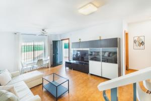 a living room with a couch and a table at Dúplex junto a la playa in Sanlúcar de Barrameda