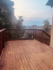 a balcony with a wooden deck with a view at Sweet Home Alibama in Nelspruit