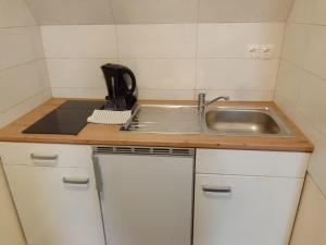 a small kitchen with a sink and a counter at SchlafHütte in Kaltenkirchen