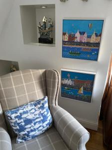 a living room with a couch and a pillow at The Captains Quarters in Berwick-Upon-Tweed