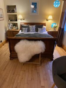 a bedroom with a bed with a white furry rug at The Captains Quarters in Berwick-Upon-Tweed
