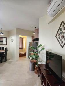 a living room with a large flat screen tv at SERIN WEST TAGAYTAY-Spacious & Comfy 2BR Unit with Parking and Balcony in Tagaytay