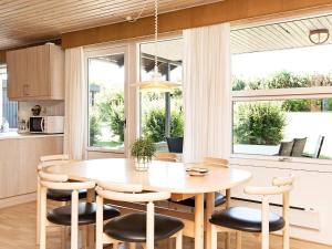 a kitchen with a dining room table and chairs at 6 person holiday home in Glesborg in Glesborg