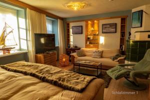 a living room with a bed and a couch at GORI Boutique Apartments – Tirol in Reutte