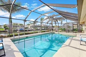 a large swimming pool with a glass ceiling at 152 Leeward Court in Marco Island