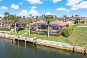 a house on the water with a dock at 152 Leeward Court in Marco Island