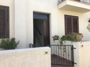 uma porta aberta de um edifício com vasos de plantas em B&B Agrodolce em San Vito lo Capo