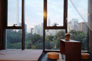 a large window with a view of a city at Romantic Log Cabin 2 - Heart of KL, near KLCC/KL Tower in Kuala Lumpur