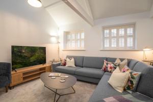 a living room with a couch and a tv at Contemporary Home by LetMeStay in Carnforth
