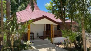 a small house with a pink roof at CED Villas in El Nido