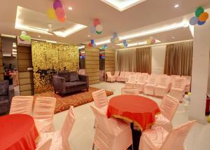a banquet hall with white chairs and tables and balloons at Hotel Mystic Inn in Jaipur