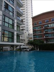 a swimming pool in front of two tall buildings at Neo2 condo 703 in Jomtien Beach