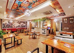 a restaurant with tables and chairs and a bar at Hotel Mystic Inn in Jaipur