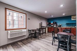 a restaurant with tables and chairs and a window at Days Inn by Wyndham Brunswick Bath Area in Brunswick