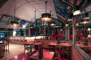 a restaurant with wooden tables and chairs and lights at Tralala Hotel Montreux in Montreux