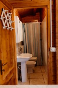 a bathroom with a sink and a toilet and a sink at Camping La Pineta in Porto Recanati