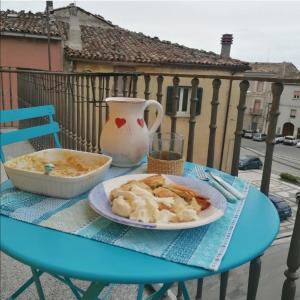 a blue table with a plate of food and a vase at Demetra Piccola Casa Vacanze in Ielsi