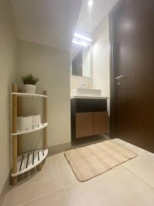 baño con lavabo, aseo y puerta en Turquaze Guesthouse en Mascate