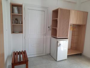 una cucina con frigorifero bianco e mobile in legno di Voula Beach a Lentas