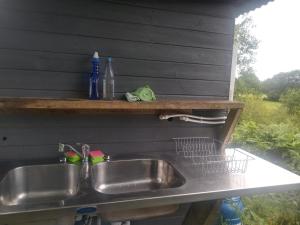 a kitchen sink with a shelf above it at Blackberry Patch in Pont Yates