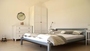 a bedroom with a bed and a dresser and a mirror at Spacious poolside villa with beautiful garden in Kringa in Pinezići +23 photos