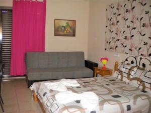 1 dormitorio con 1 cama y 1 sofá en Chios Rooms MyView, en Karfas
