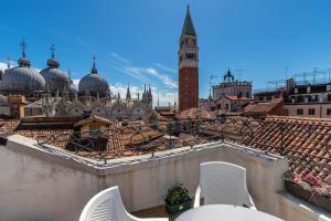 a balcony with two chairs and a view of a city at Hotel ai do Mori in Venice