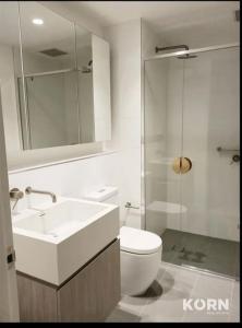 a bathroom with a toilet and a sink and a shower at Realm 1206 in Adelaide