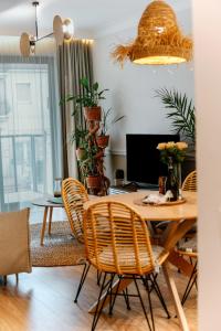 a dining room with a wooden table and chairs at Boho przy plaży - Rezydencja Niechorze in Niechorze