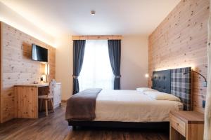 Postel nebo postele na pokoji v ubytování Hotel Piccola Baita